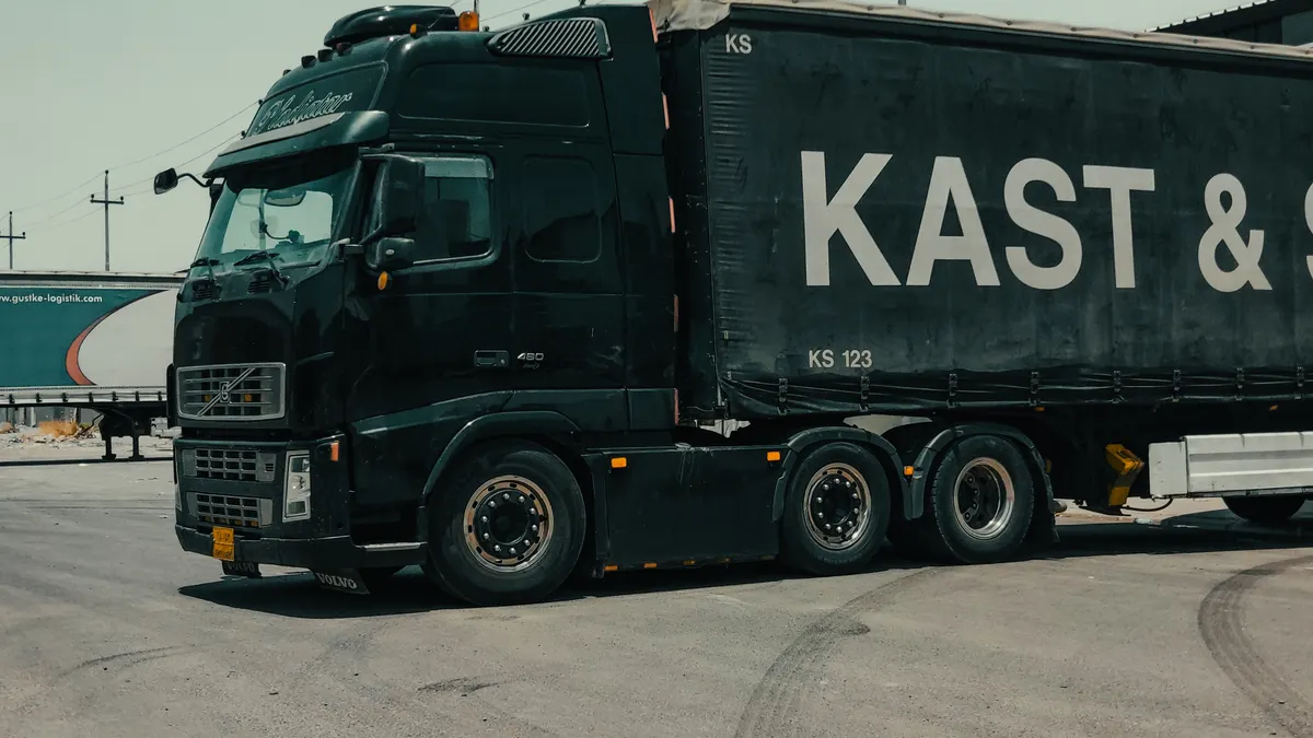 A large industrial truck parked in an urban setting, showcasing transportation industry visuals.