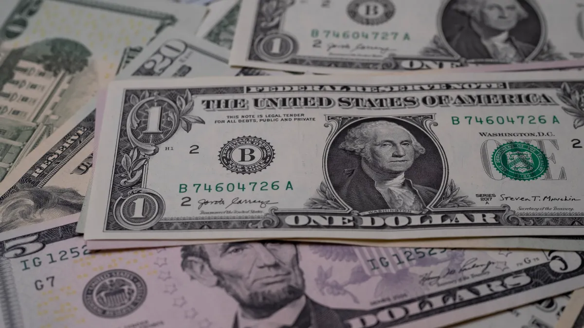 A detailed view of multiple denominations of US dollar bills symbolizing wealth and finance.