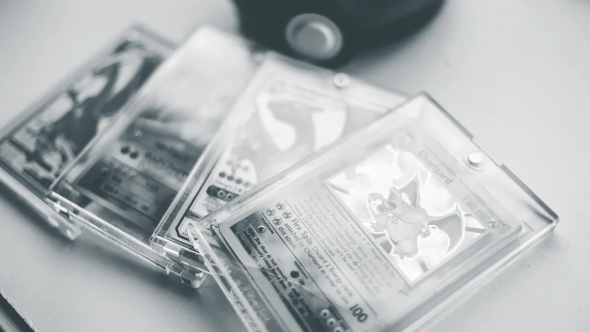Close-up of collectible Pokemon cards in protective cases, emphasizing preservation and value.