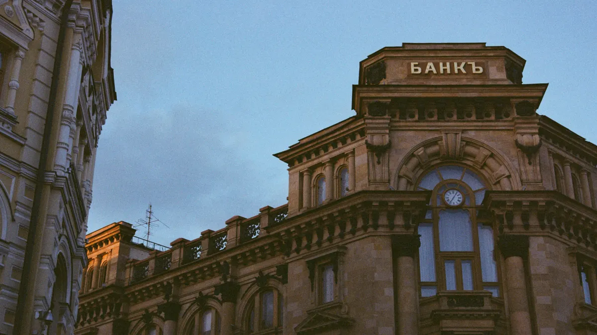 Classic architectural style of a historic bank building under clear blue sky.